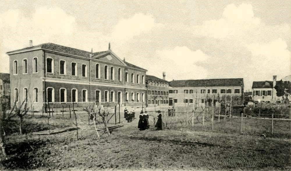 La facciata interna dell'Istituto San Gioacchino vista dal giardino, con suore e allieve sul vialetto
