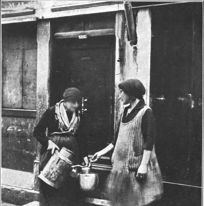 Due donne con bidoni del latte sulla porta di casa a Venezia